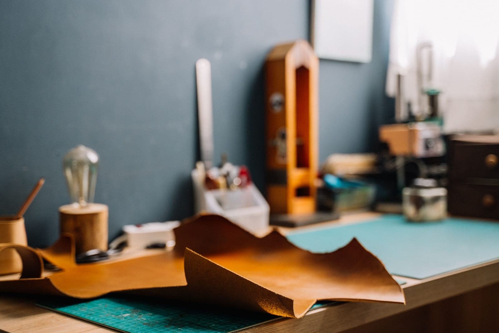 Leather-working hand tools laid out on a craftsman's bench